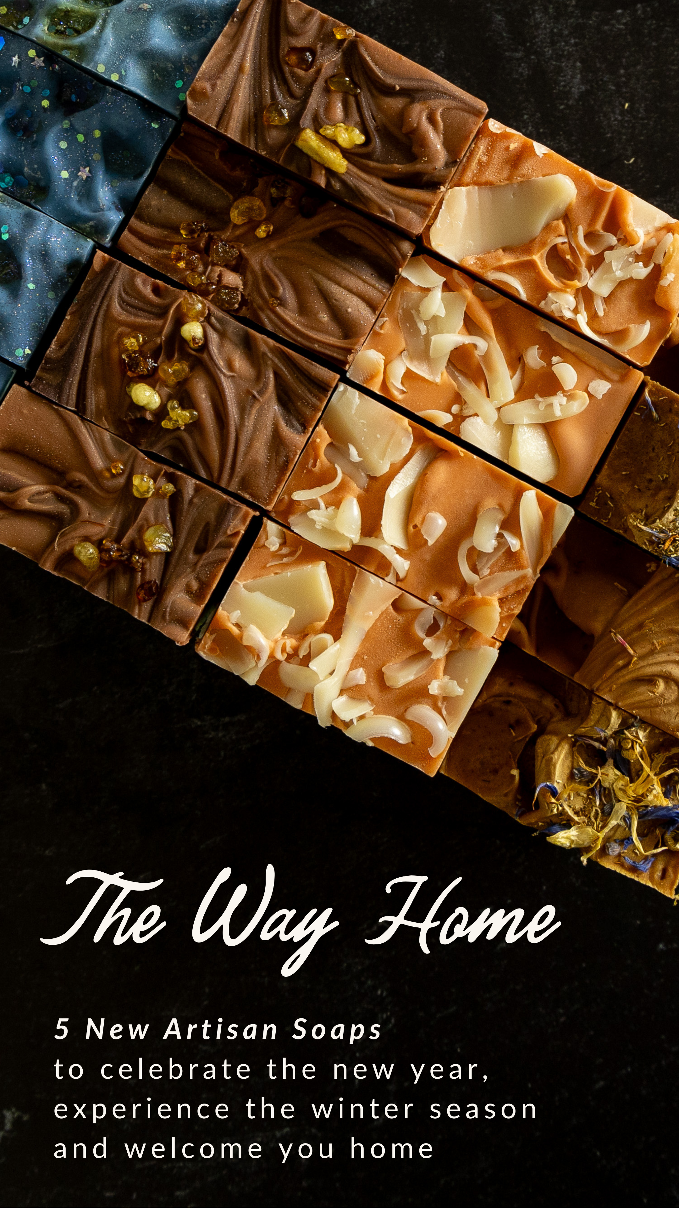 Artisan soap bars with different textures and colors on a dark background, featuring the brand 'The Way Home'.