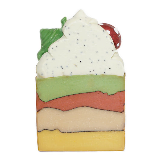 A frosted bar of soap with multiple layers and a design resembling a stack of books with a teapot and a mushroom on top