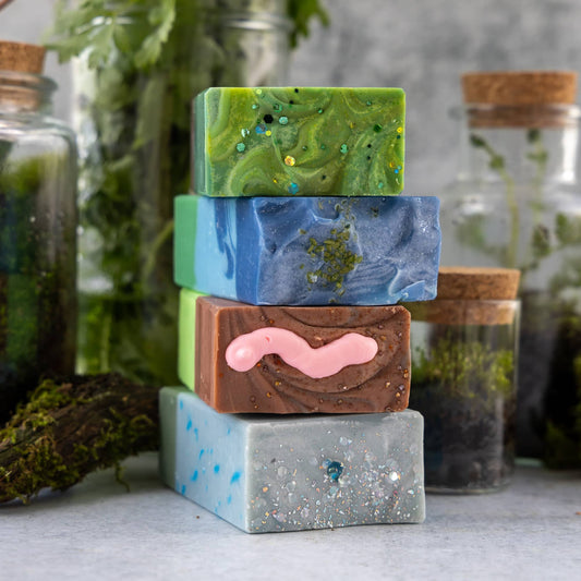 Stack of colorful soap bars with natural elements in the background