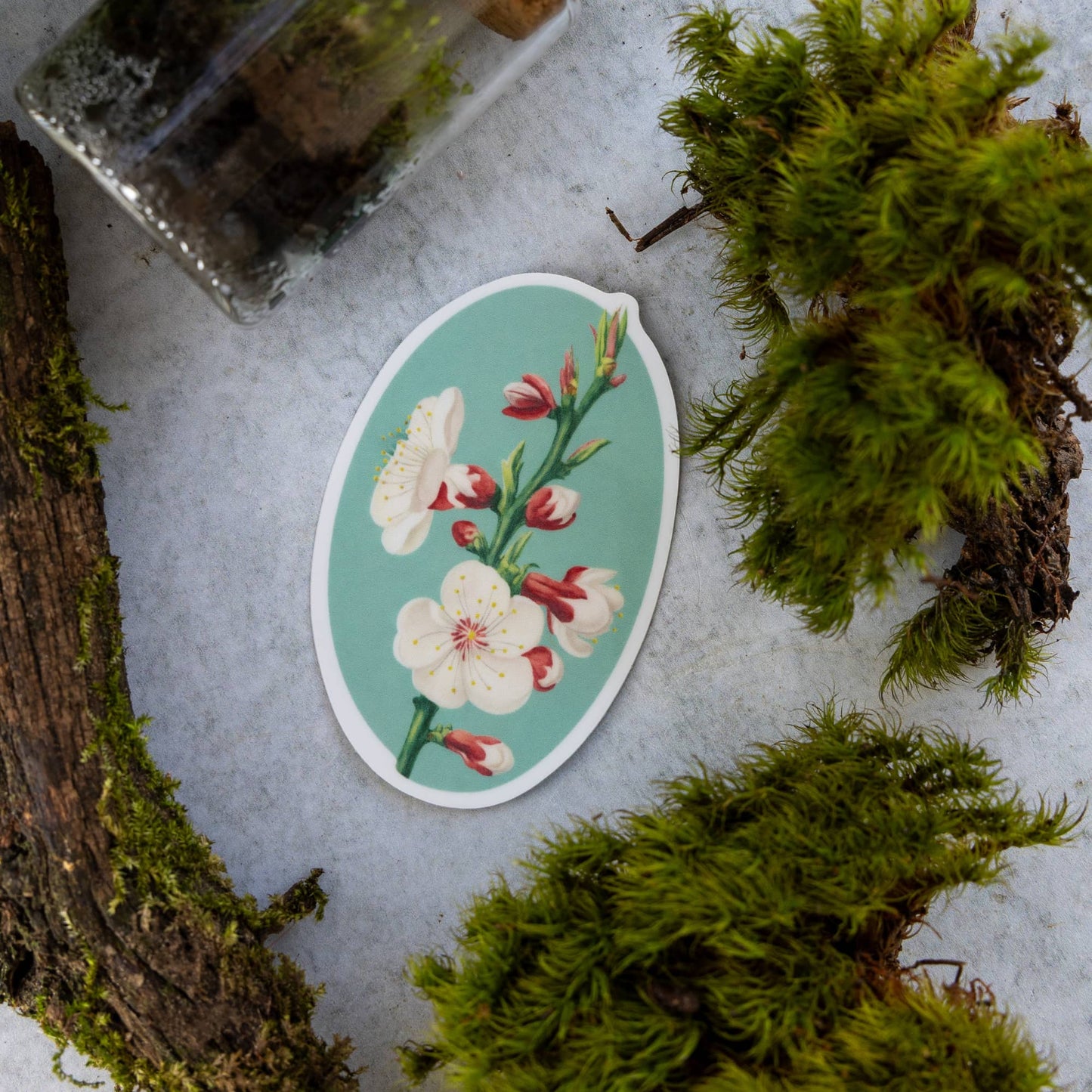 Floral sticker on a textured surface with moss
